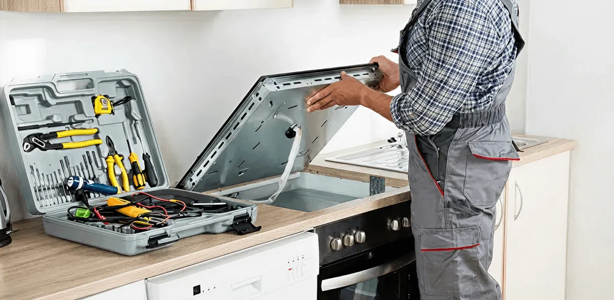 Handyman repairing a cooktop and checking wiring connections in Dallas, TX