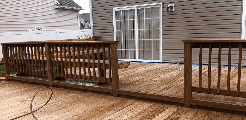 Deck sealing service protecting a backyard wood deck and railings in Dallas, TX