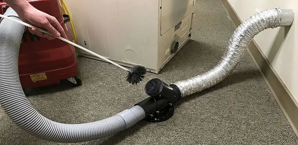 Dryer vent cleaning service removing lint from a dryer duct connection in Dallas, TX