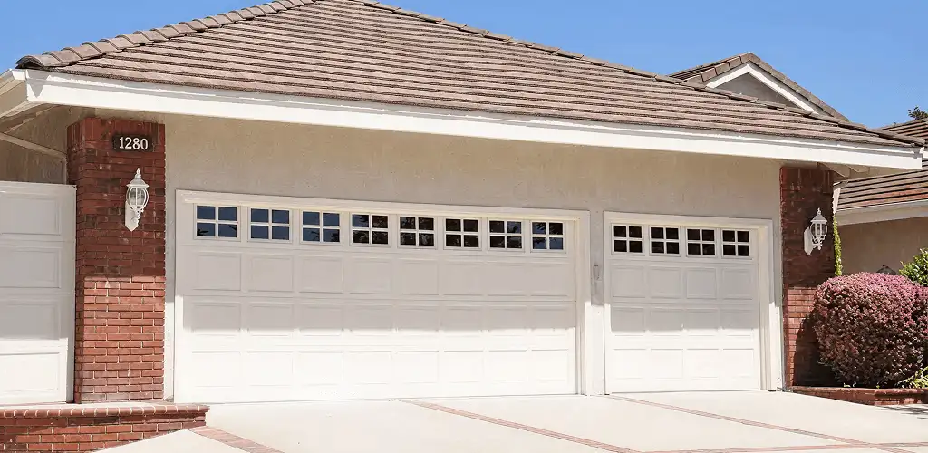 Residential garage door repair service for a double garage door in Dallas, TX