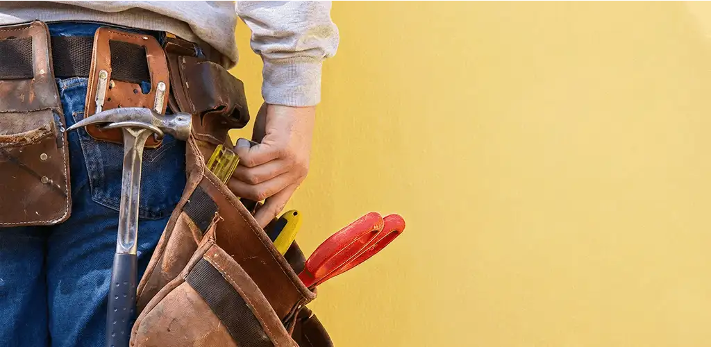 Handyman with tool belt ready for home repairs and maintenance in Dallas, TX