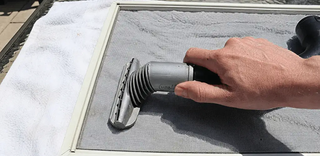 Window screen repair cleaning and fixing a damaged screen mesh in Dallas, TX