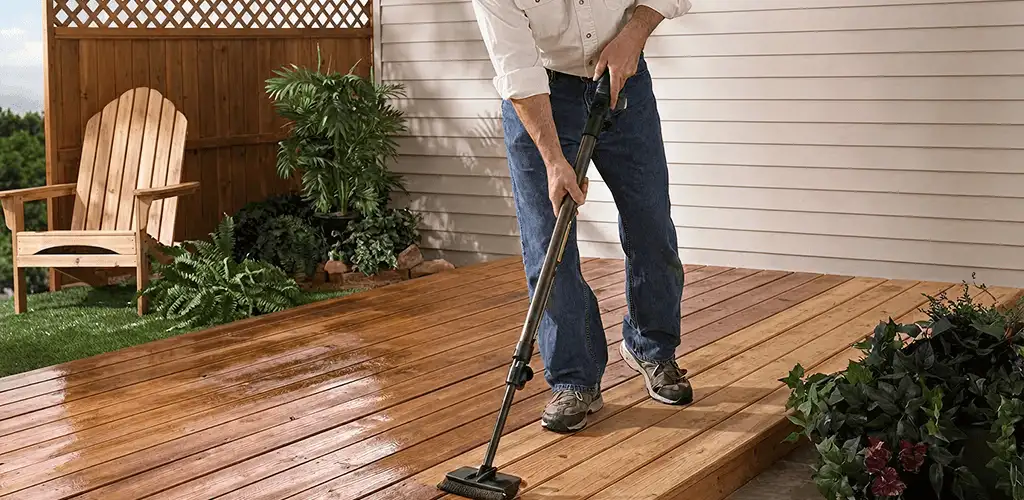 Deck staining service applying stain to a backyard wood deck in Dallas, TX